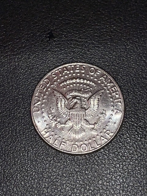 2020 Kennedy Half Dollar off-center strike error showing shifted design and visible blank planchet crescent