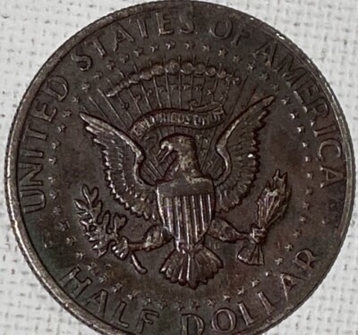 2020 Kennedy Half Dollar missing clad layer error showing exposed copper-colored inner core on coin face