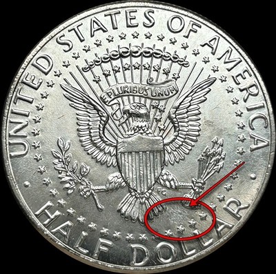 2020 Kennedy Half Dollar struck-through error showing incuse impression of foreign debris in coin surface